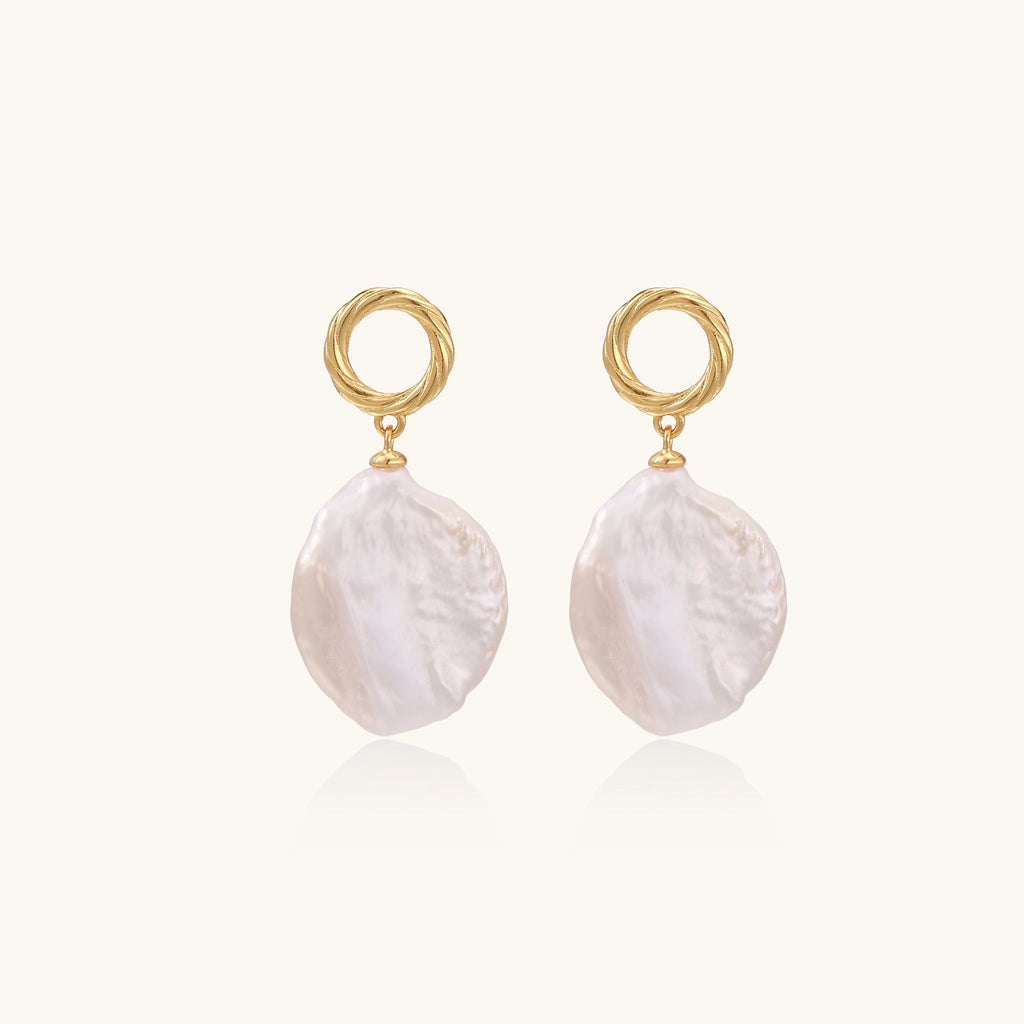 18K gold vermeil twisted circle studs with organic white baroque pearl drops on cream background